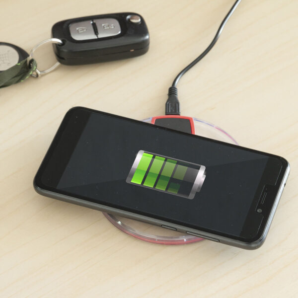 Carregador Sem Fios Qi InnovaGoods – Carregamento Rápido e Seguro Smartphone a carregar no carregador sem fios Qi InnovaGoods, prático e seguro para uso diário